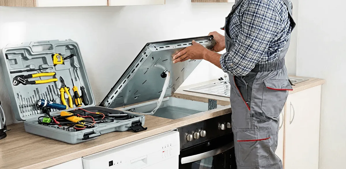 Handyman repairing a cooktop and checking wiring connections in Philadelphia, PA