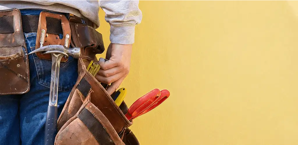 Handyman with tool belt ready for home repairs and maintenance in Philadelphia, PA