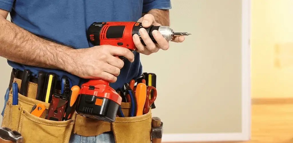 Handyman holding a power drill for home repairs and installations in Philadelphia, PA