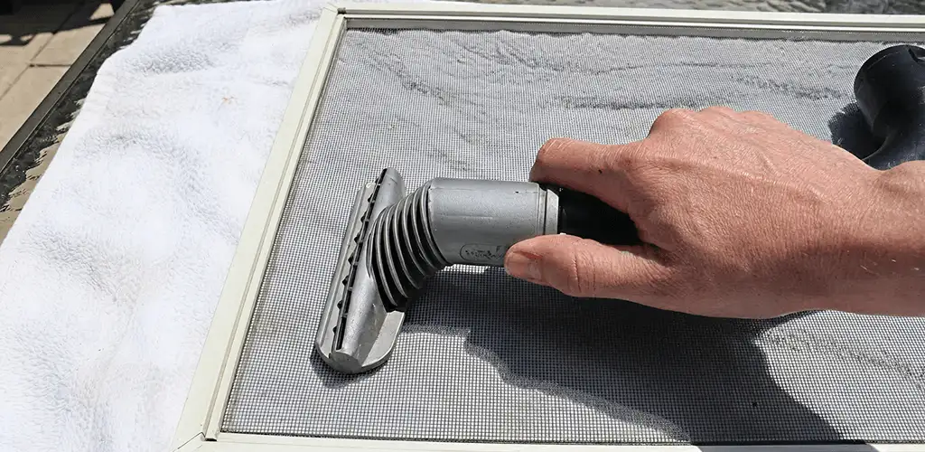 Window screen repair cleaning and fixing a damaged screen mesh in Philadelphia, PA
